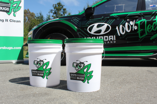 Bar's Bugs Buckets in front of Hayden Paddon's EV Rally car